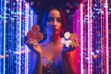A cheerful woman in traditional clothing using her smartphone during a festive moment, showing how easily the CROWNDB app fits into everyday life.