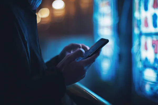 A glamorous woman holding casino chips in a neon-lit environment, representing the premium online casino atmosphere of CROWNDB.