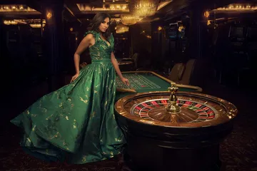 A man celebrating a winning moment on his laptop while gaming symbols float around him, capturing the excitement of CROWNDB games.